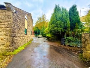 Extensive driveway spanning the side and rear of the property